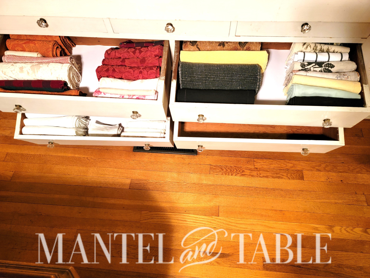 three drawers full of organized napkins, and one empty drawer