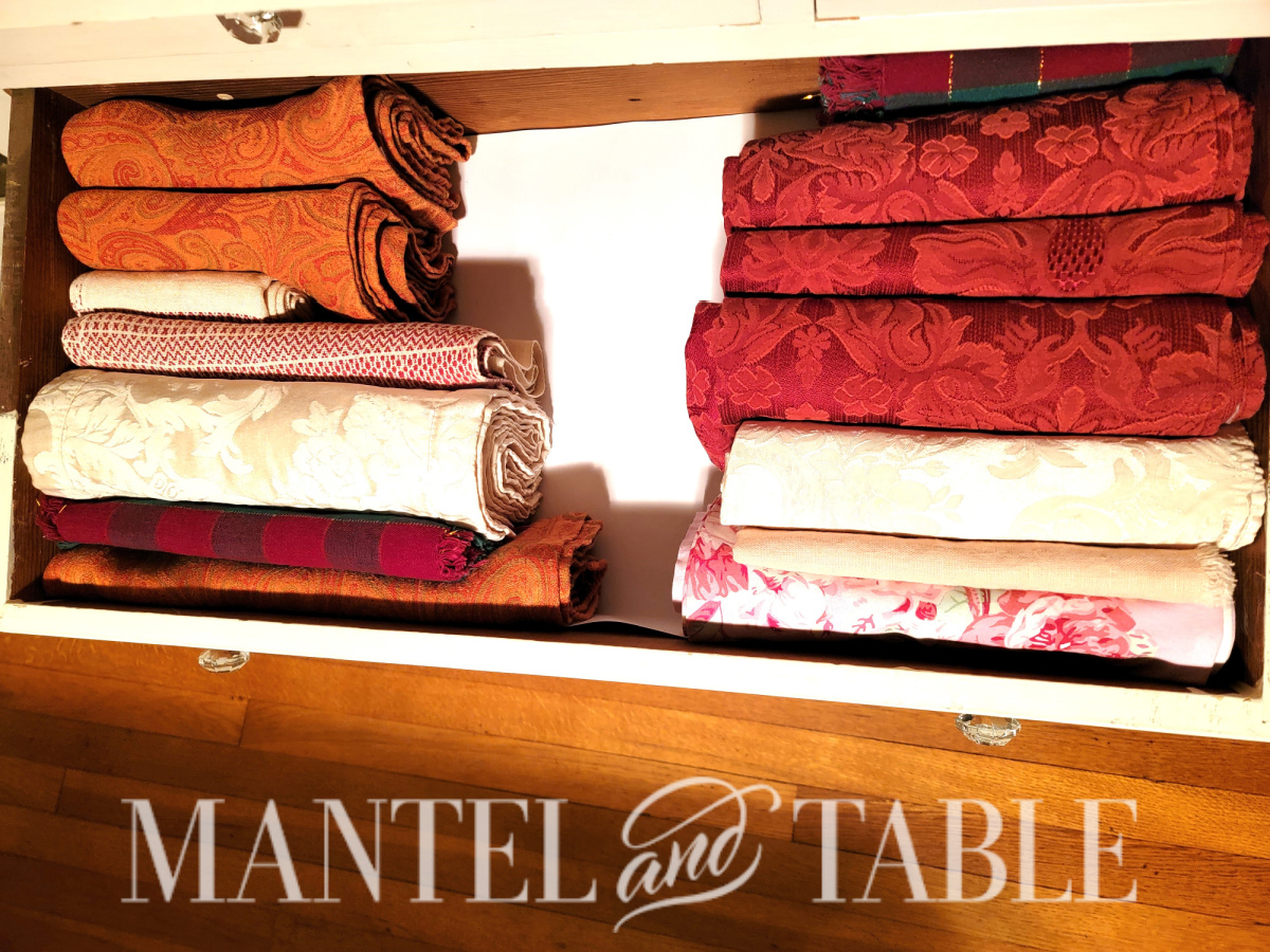 Storing Napkins - rows of folded pink and red napkins in a drawer