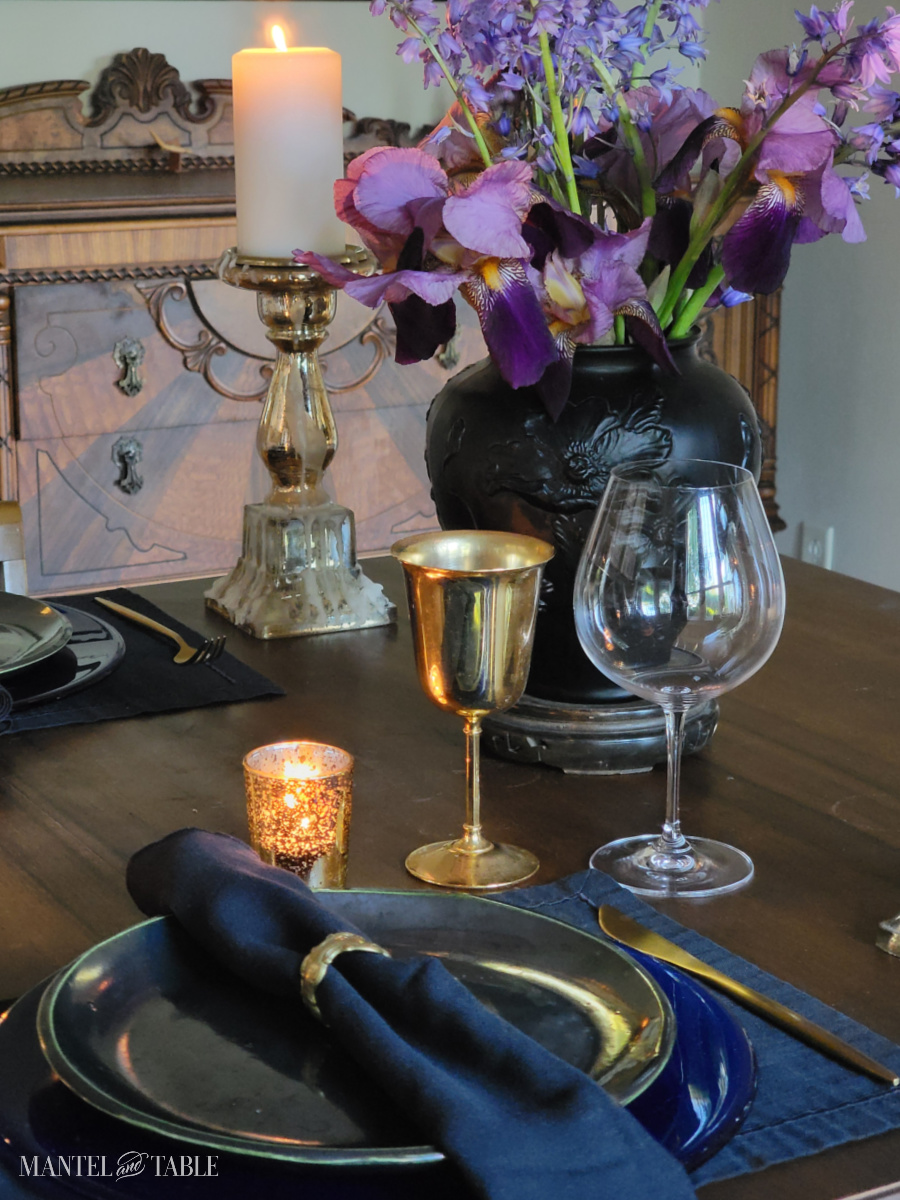 Dark and moody tablescape featuring black placemats and napkins