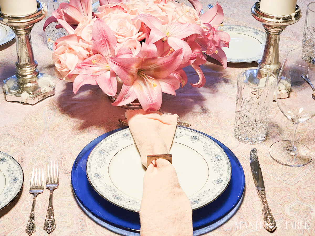 Formally set table and closeup of pink roses and lilies in an arrangement