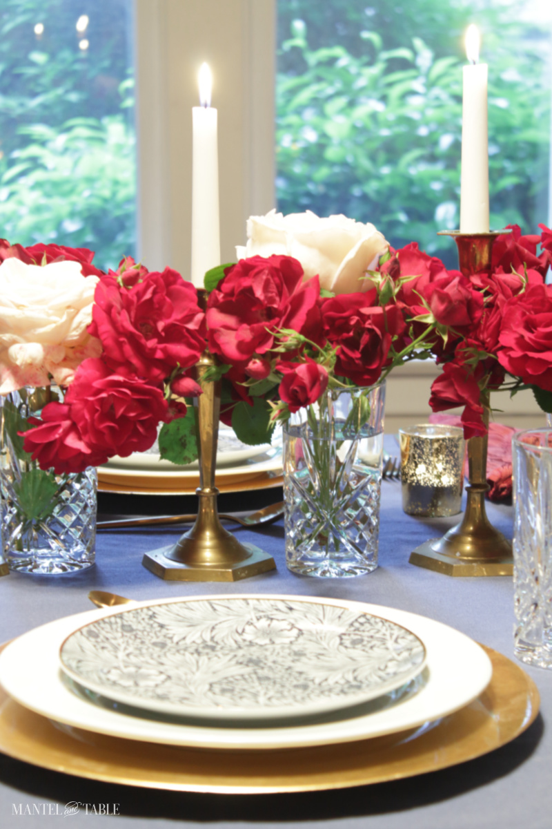 table with rose centerpiece and taper candles