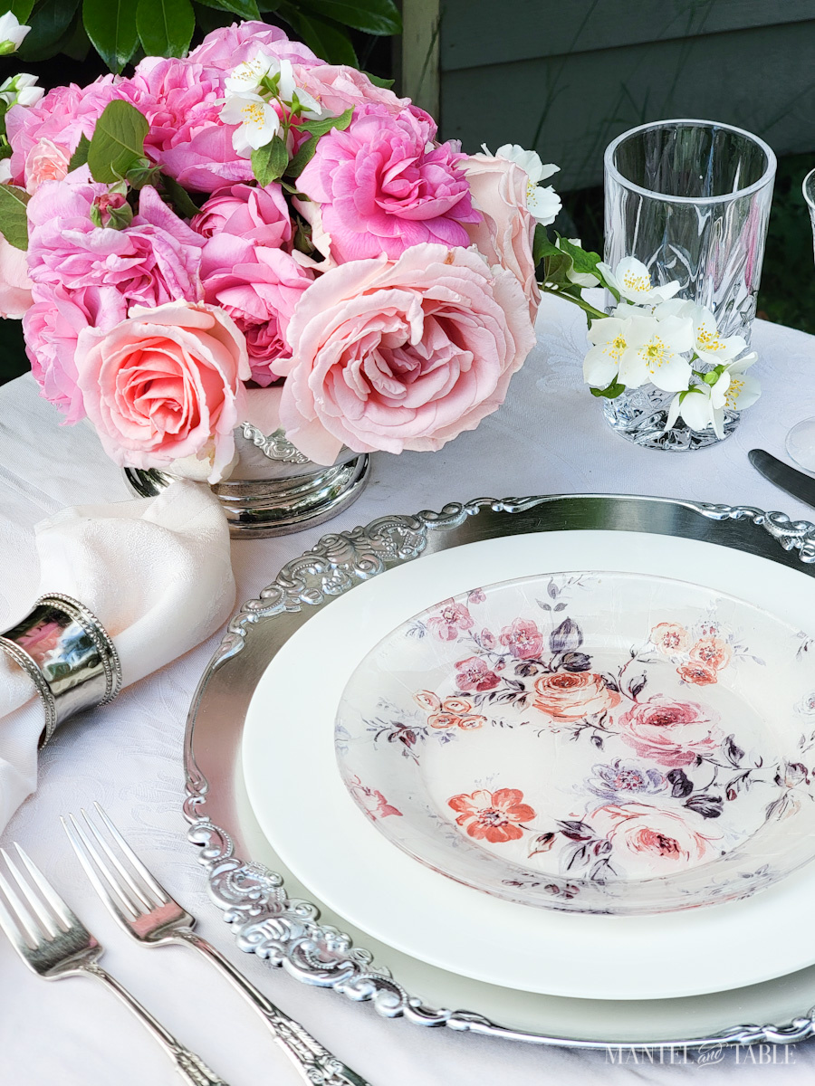 summer pink tablescape with a silver bowl of pink roses