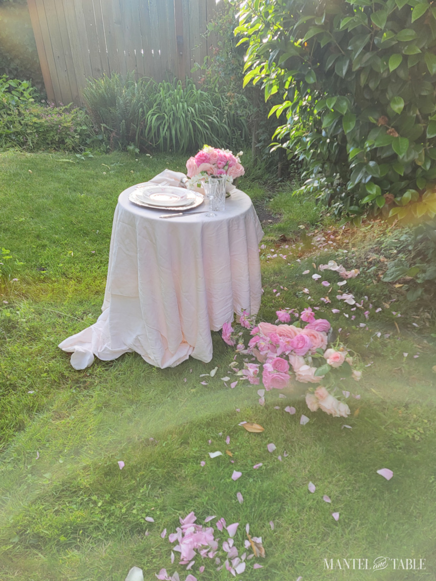 Small table with pink setting in the garden