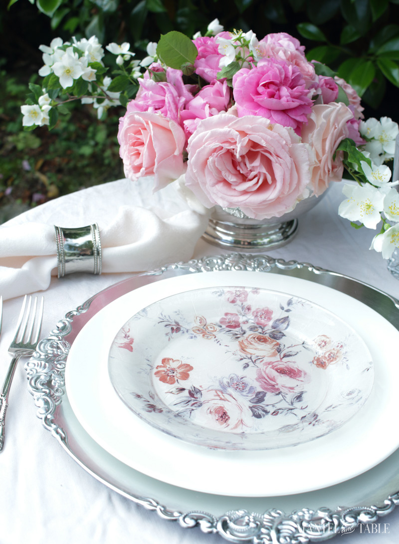 Closeup of plate stack on a pink decorated table