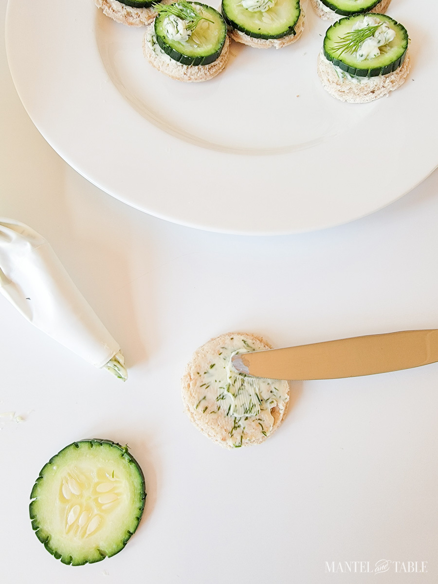 spreading dill butter onto bread round