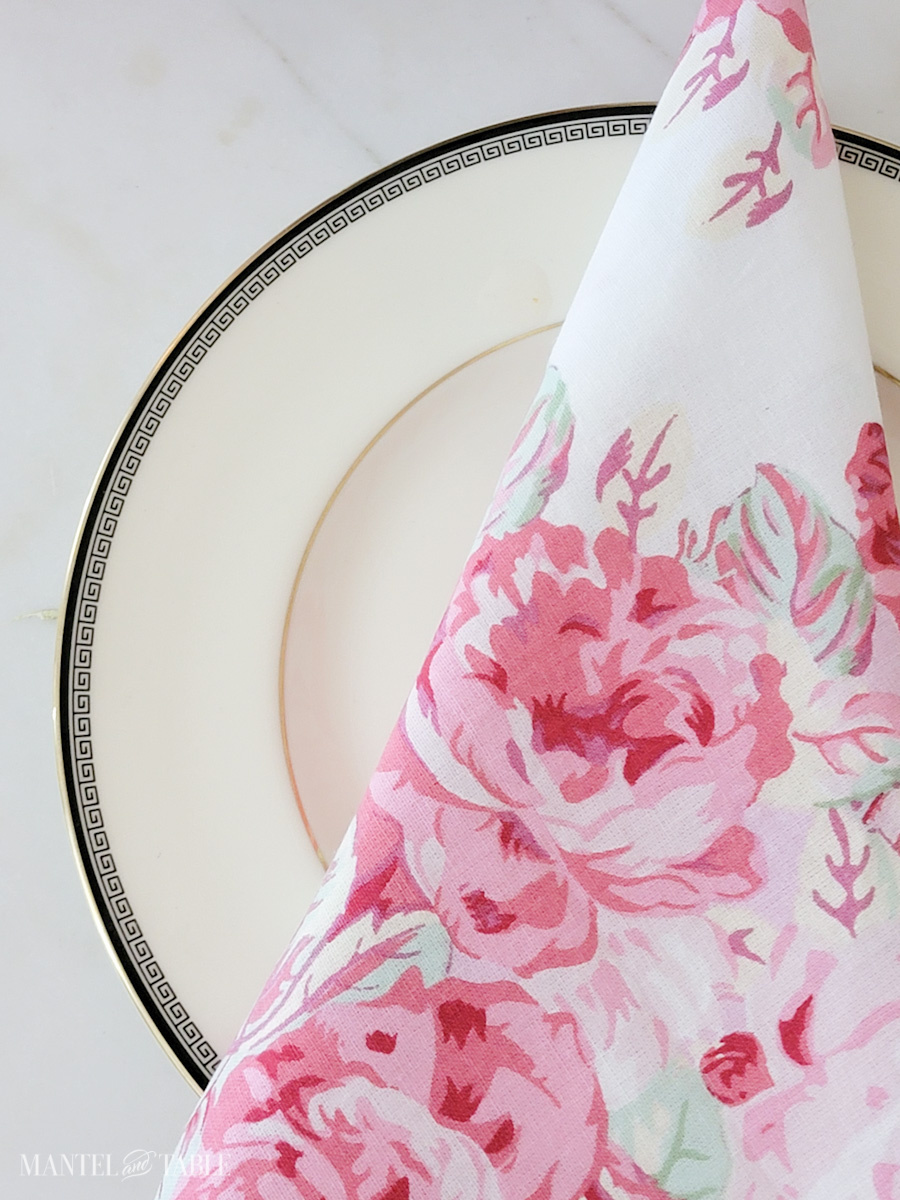 Luncheon plate and pink floral napkin closeup