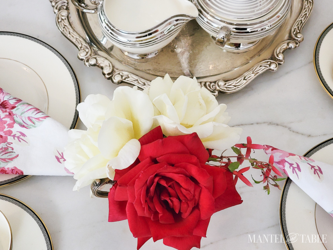 table with small red and yellow rose centerpiece