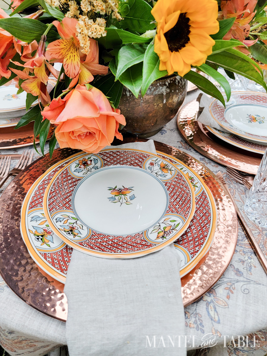 Formal table setting with flower centerpiece in a copper pot