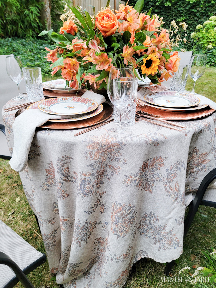 Outdoor round tablescape with rectangular tablecloth