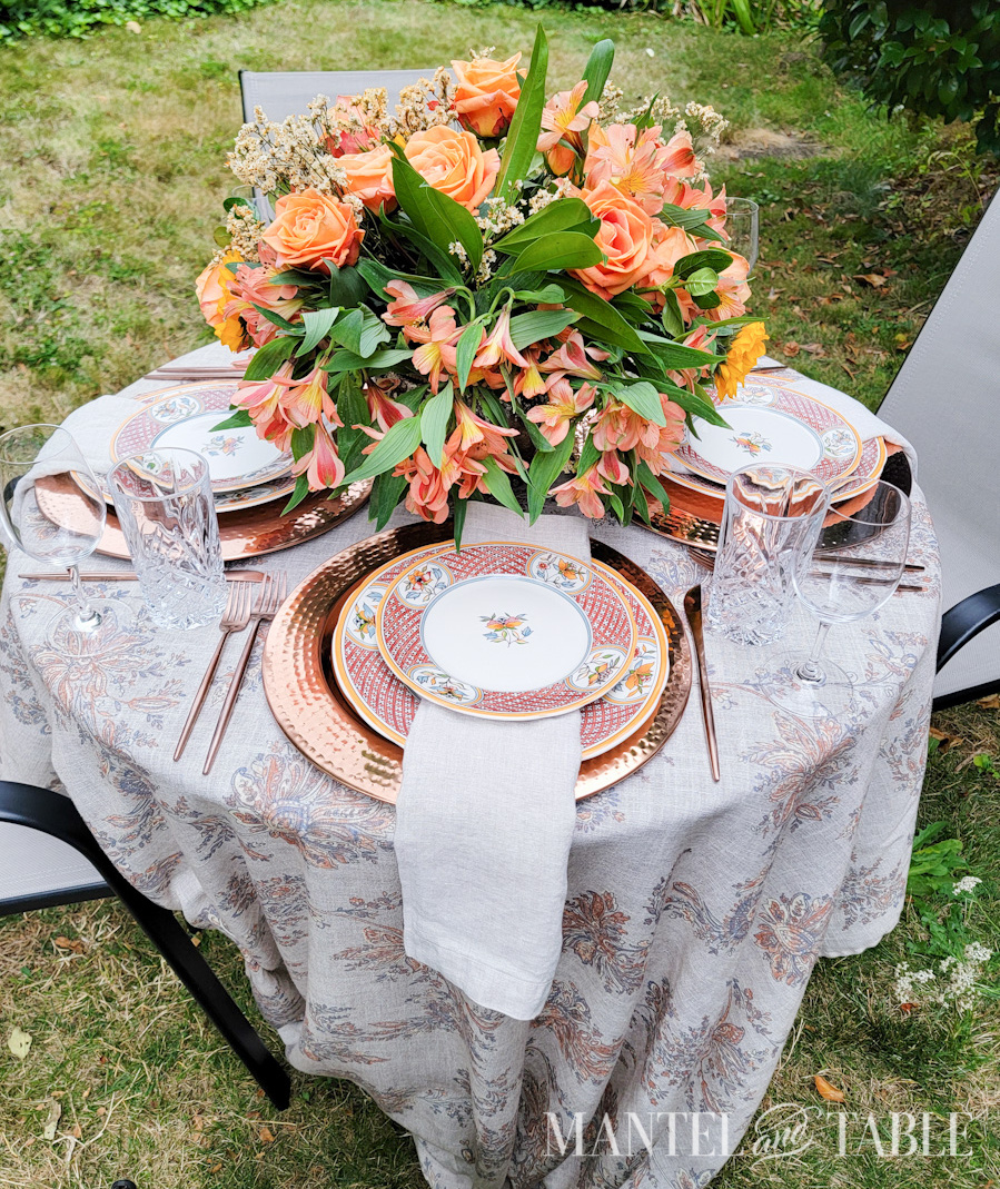 Tan tablecloth and napkins in an outdoor table setting