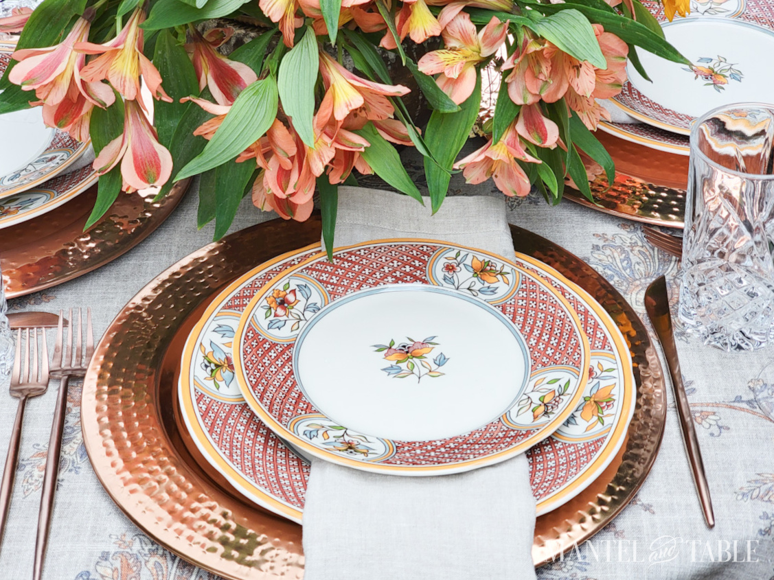 Beautiful fall tablescape with copper chargers and flatware