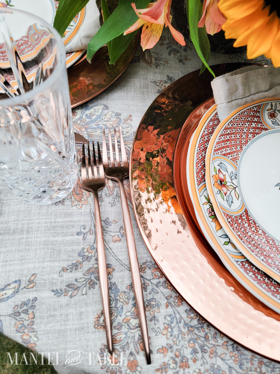 Copper forks on a table in a place setting