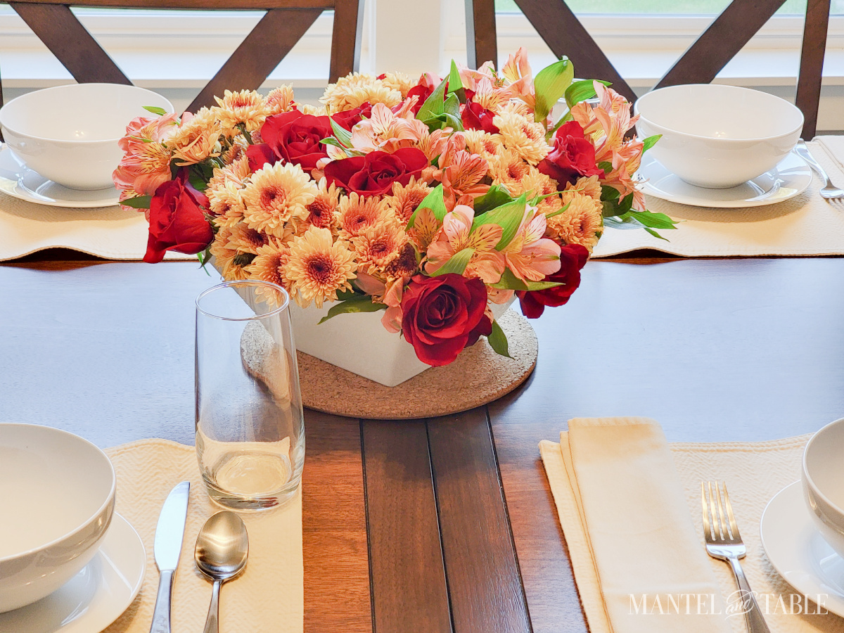 brunch table setting with fall colored flower centerpiece
