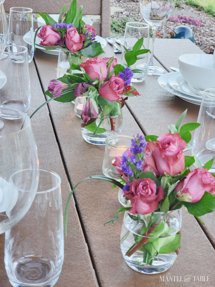 mauve and purple flowers down the center of a tablescape
