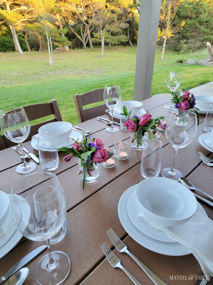 white dishes and pink flowers in a table setting