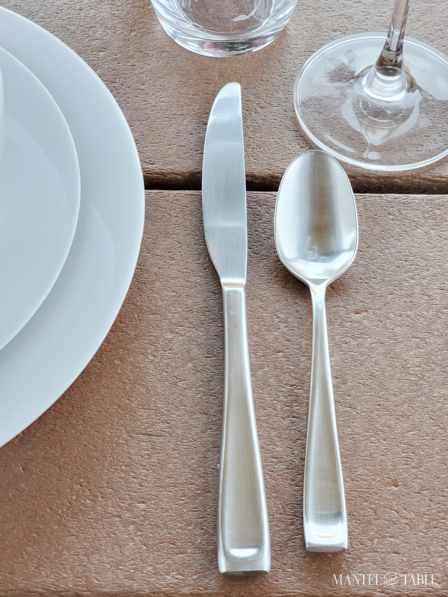 stainless knife and spoon on a table setting closeup