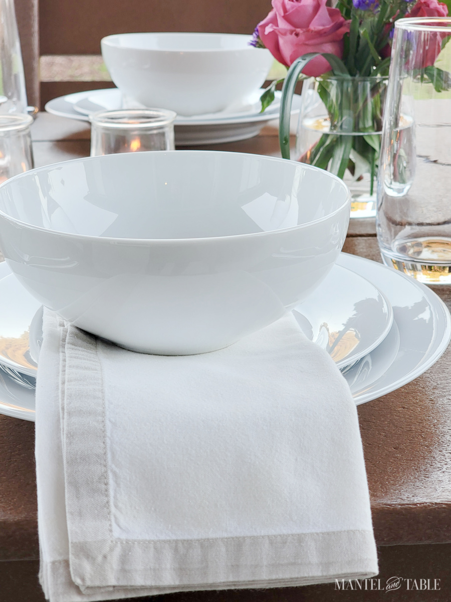 closseup of a white plate stack on a Sunset tablescape